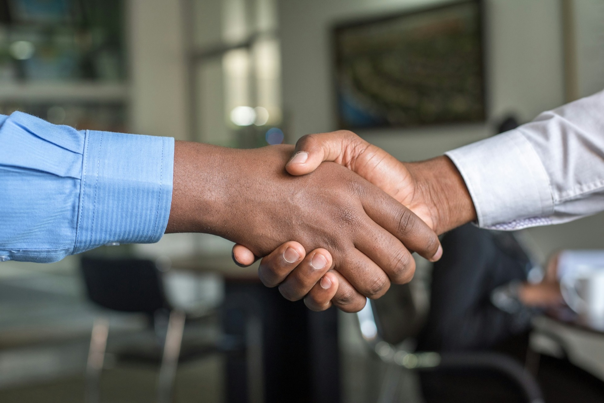 Two trade professionals shaking hands on a high-stakes deal